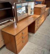 A mid 20th century teak dressing table together with two chests of drawers and a laundry box,