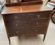An Edwardian mahogany dressing chest with two short and top long drawers on reeded legs