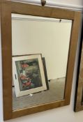 A modern oak framed wall mirror