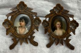 A pair of black forest easel frames carved with flowers and leaves together with a pair of