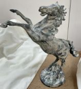 A cast iron model of a rearing horse