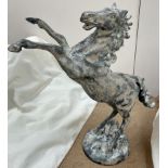 A cast iron model of a rearing horse