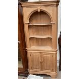 A 20th century pine standing corner cupboard,