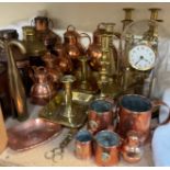 An Anniversary clock, under a glass dome together with brass candlesticks, copper lamps,