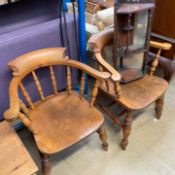 A pair of smokers bow elbow chairs together with a hanging corner unit