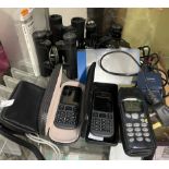 A collection of mobile phones together with a camera,