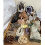 An amethyst geode together with a collection of rock and crystal samples and a pair of hardstone