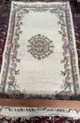 An Indian rug with a cream ground and floral decoration together with another Indian rug