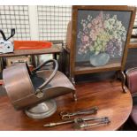 A copper coal scuttle together with fire irons and a woolwork fire screen