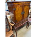 A reproduction walnut drinks cabinet,