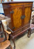 A reproduction walnut drinks cabinet,