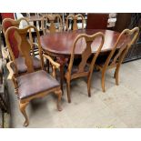 A reproduction mahogany extending dining table with an additional leaf together with a set of six