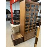 An Haberdashers cabinet with twenty four drawers and a tambour fronted base,