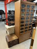 An Haberdashers cabinet with twenty four drawers and a tambour fronted base,