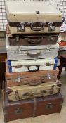 A Rev Robe suitcase together with a collection of suitcases and a trunk