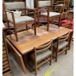 A mid 20th century Danish teak tiled top extending dining table and eight chairs,