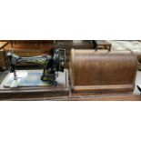 A Singer sewing machine in a domed case