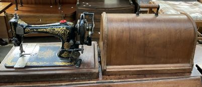 A Singer sewing machine in a domed case