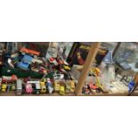 A Scalextric action set together with various toy cars, trucks, glass flying horse,