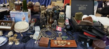 A collection of hats, elephant figure, belts, plates,