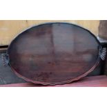 A 19th century mahogany twin handled gallery tray with a wave rim
