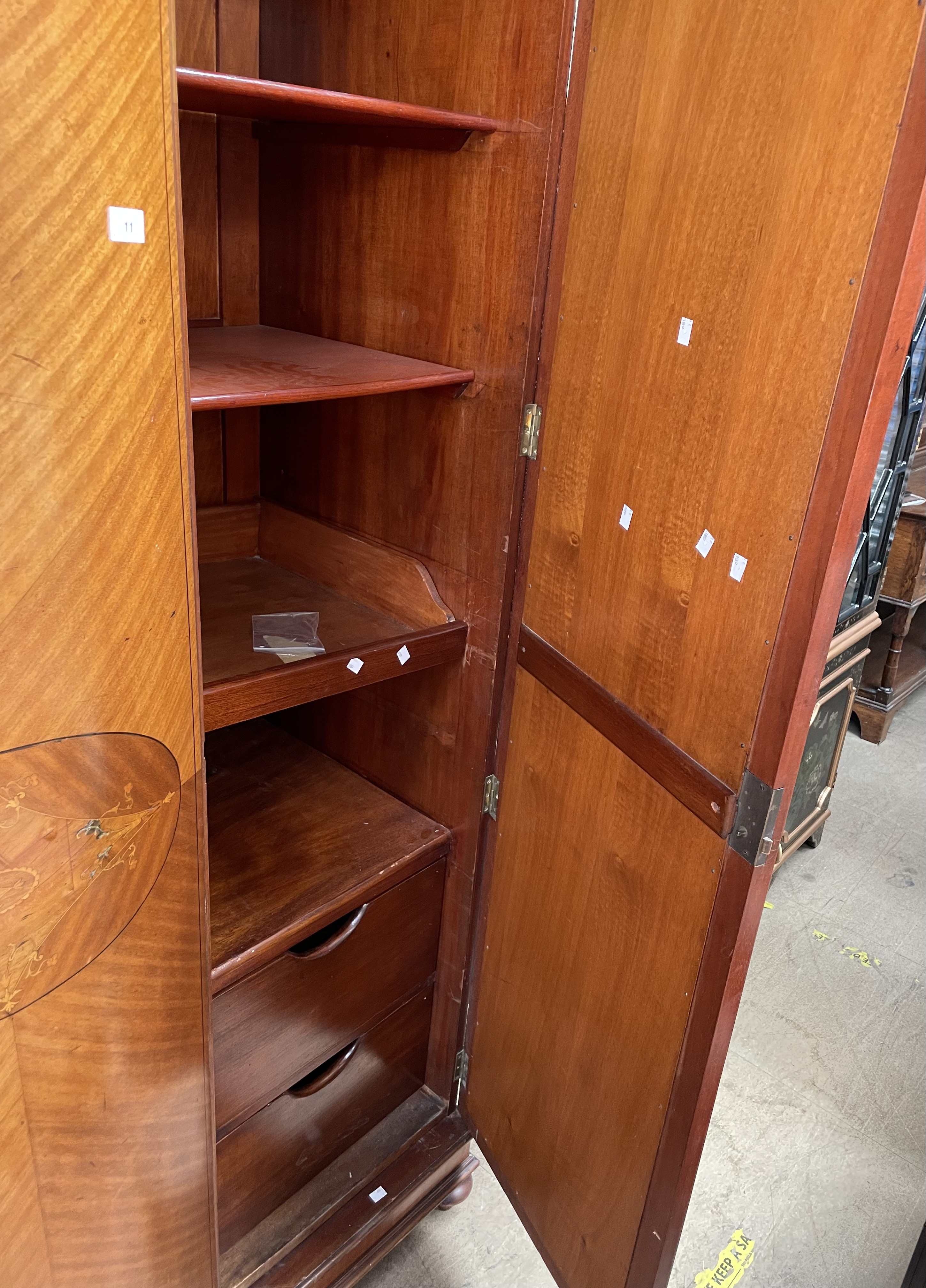 An Edwardian mahogany wardrobe, the moulded cornice above two mirrored doors on ball feet, - Image 2 of 4