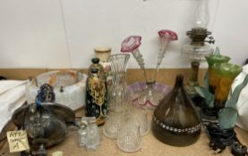 An oil lamp with a clear glass reservoir together with an epergne, table lamps, ceiling lamp,