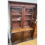 A Victorian mahogany bookcase, with a moulded cornice above a pair of glazed doors,