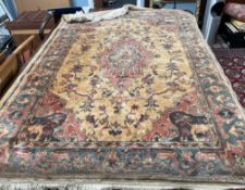 A rug with a gold ground decorated with a central medallion and spandrels together with a pink