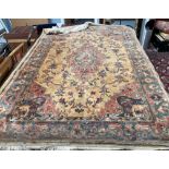 A rug with a gold ground decorated with a central medallion and spandrels together with a pink