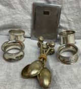 four assorted silver napkin rings together with electroplated spoons,