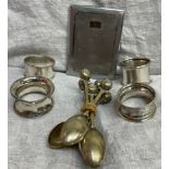 four assorted silver napkin rings together with electroplated spoons,