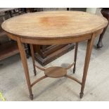 An Edwardian mahogany occasional table with an oval top on square tapering legs and spade feet