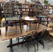 A 20th century oak refectory dining table together with six wheel back dining chairs and a walnut