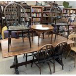 A 20th century oak refectory dining table together with six wheel back dining chairs and a walnut