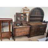 A 20th century oak dresser with a domed top and carved drawers and doors,