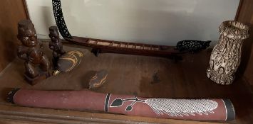 A Didgeridoo, together with carved figures,