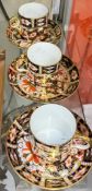 A set of three Royal Crown Derby 2451 pattern coffee cans and saucers