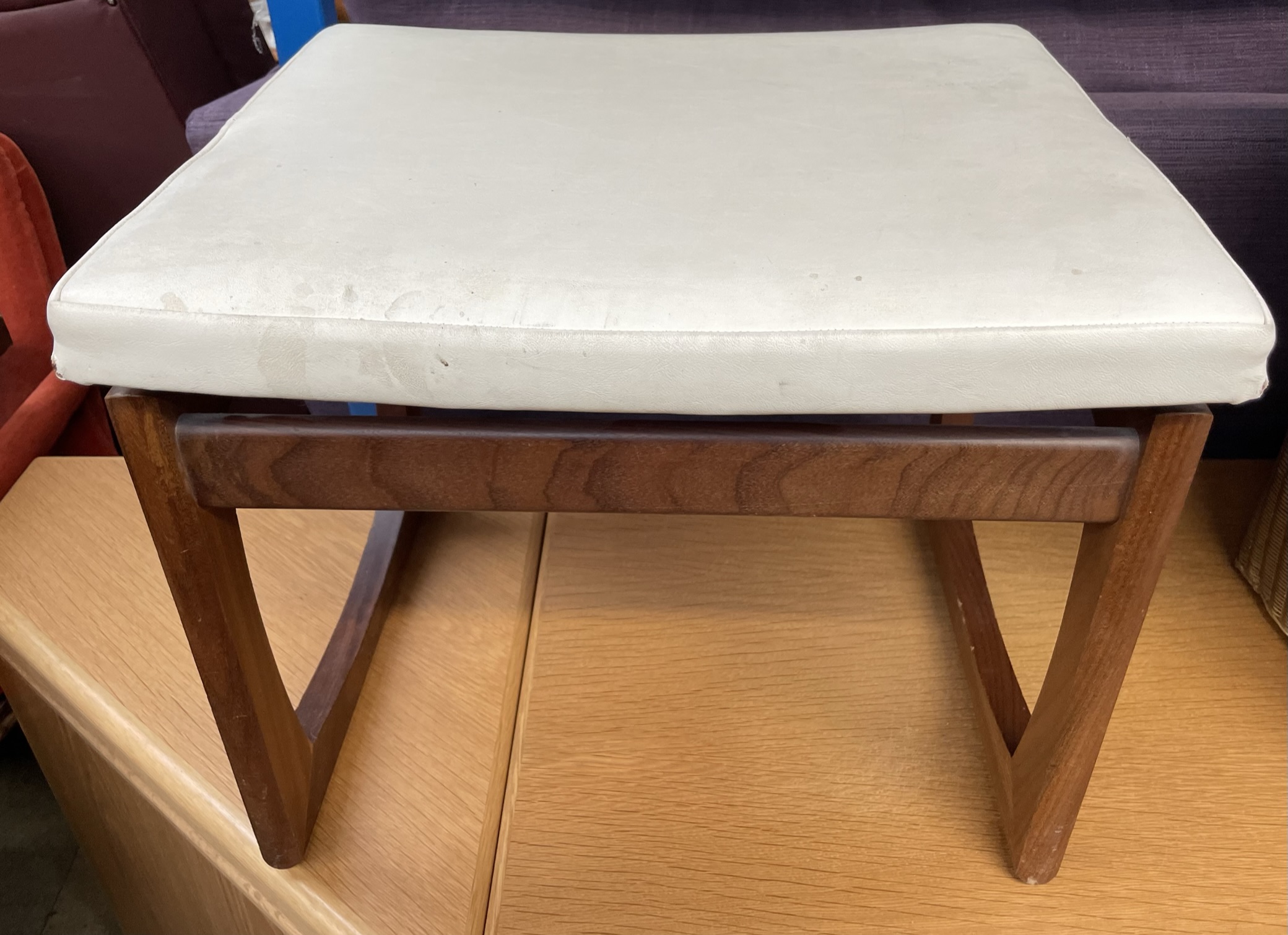 A mid 20th century teak and upholstered footstool CONDITION REPORT: All furniture