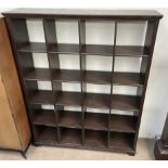 A modern stained pine bookcase with twenty compartments