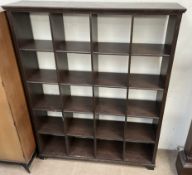 A modern stained pine bookcase with twenty compartments
