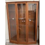 A modern teak effect three door display cabinet with glass shelves,