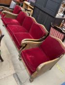 A three piece bergere suite with a double caned back and arms, carved with leaves on lions paw feet,