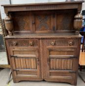 A 20th century oak court cupboard with a central cupboard door,