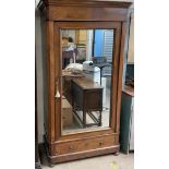 A continental walnut armoire, with a moulded cornice above a mirrored door and drawer to the base,