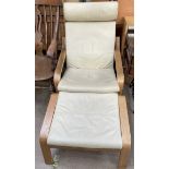 A cream upholstered elbow chair and matching footstool