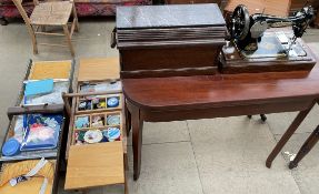 A Singer sewing machine together with two sewing boxes and contents