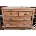 A small pine chest with a rectangular top above two short and two long drawers on turned feet
