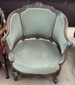 A continental carved and upholstered tub chair decorated with a central shell,