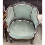 A continental carved and upholstered tub chair decorated with a central shell,